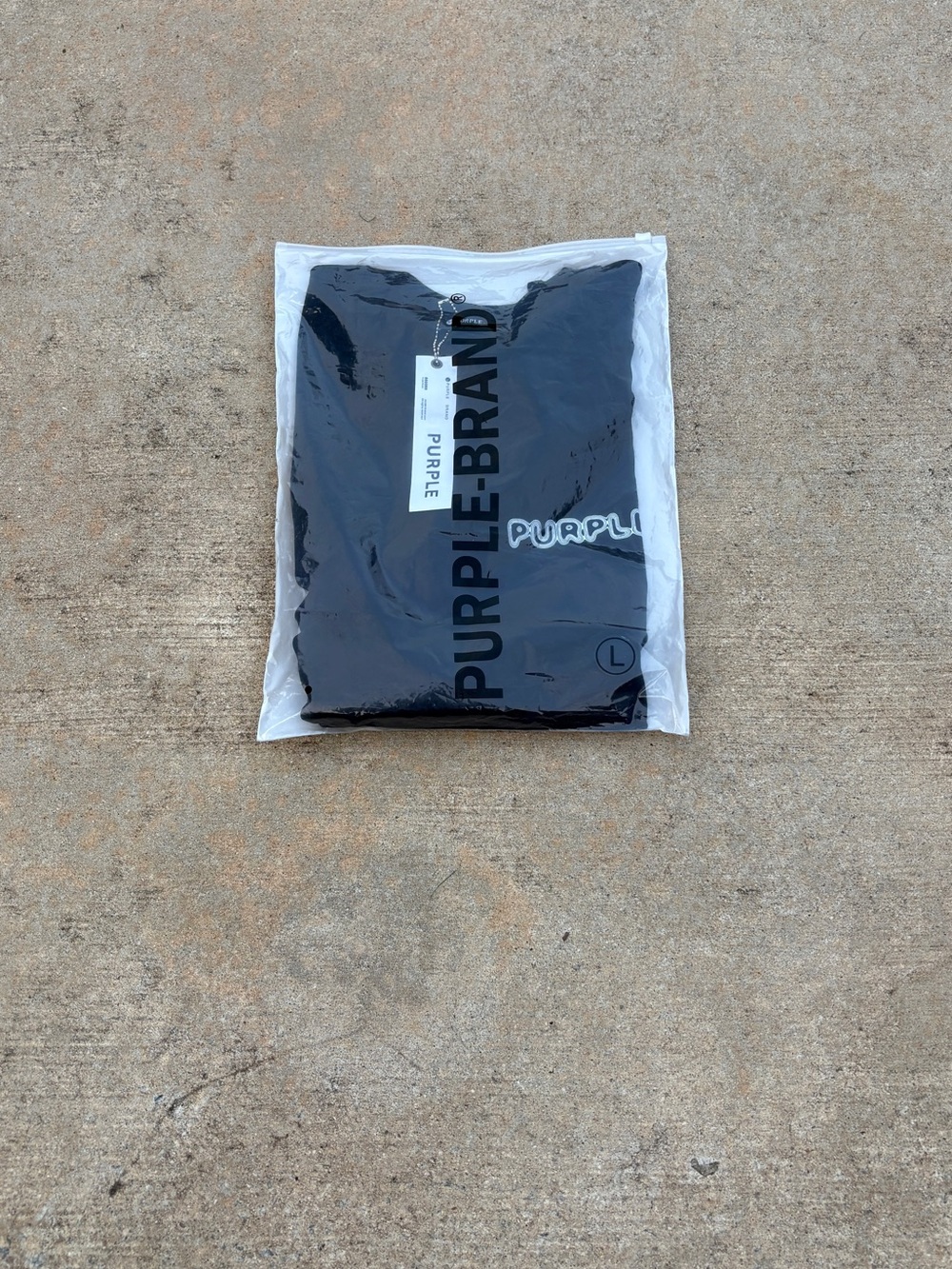 Purple Brand Black Tee in Protective Packaging